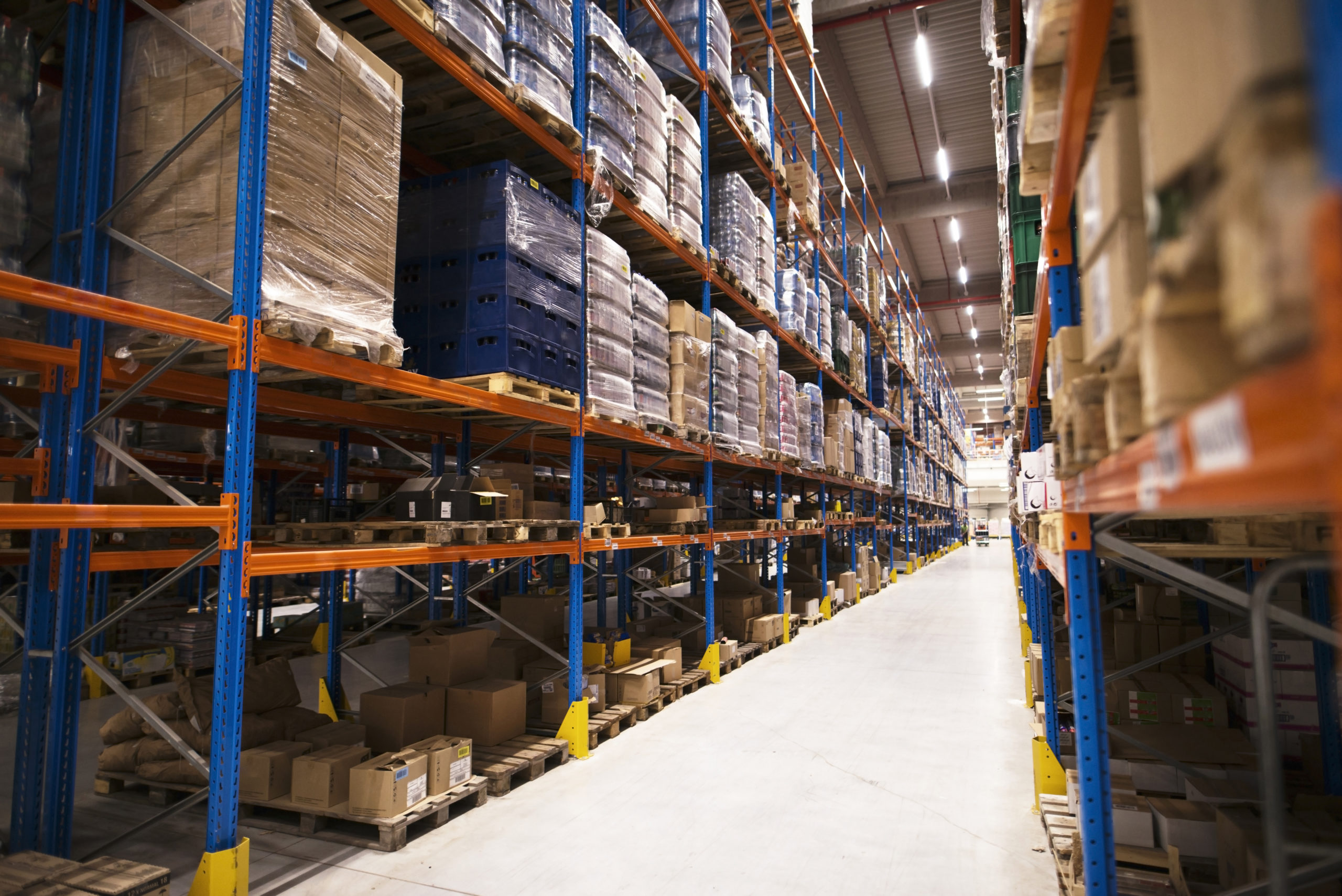 interior-of-large-distribution-warehouse-with-shelves-stacked-with-palettes-and-goods-ready-for-the-market