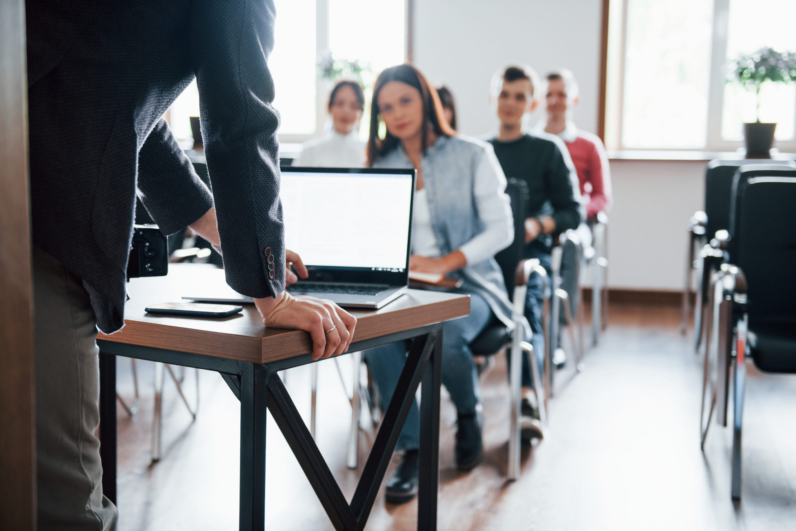 using-laptop-group-of-people-at-business-conference-in-modern-classroom-at-daytime